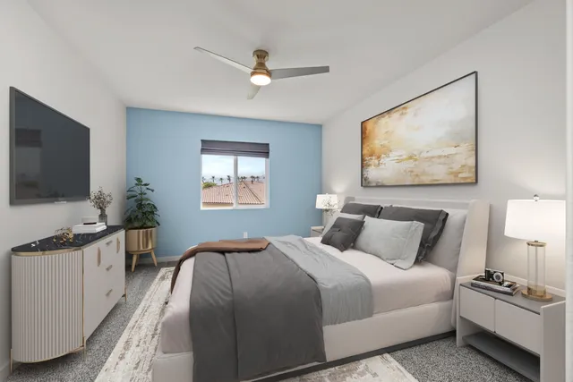 a bedroom with a bed and a flat screen tv