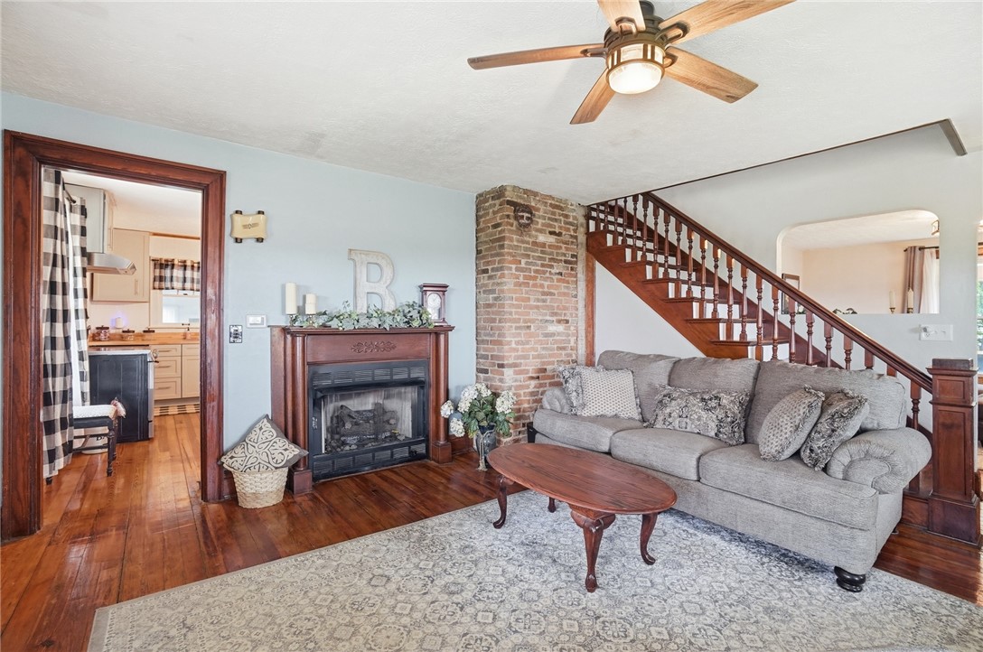 6155 North Union Road Clayton, OH 45315 - Photo 13 of 59 This inviting living space features rich hardwood flooring and a classic brick fireplace.