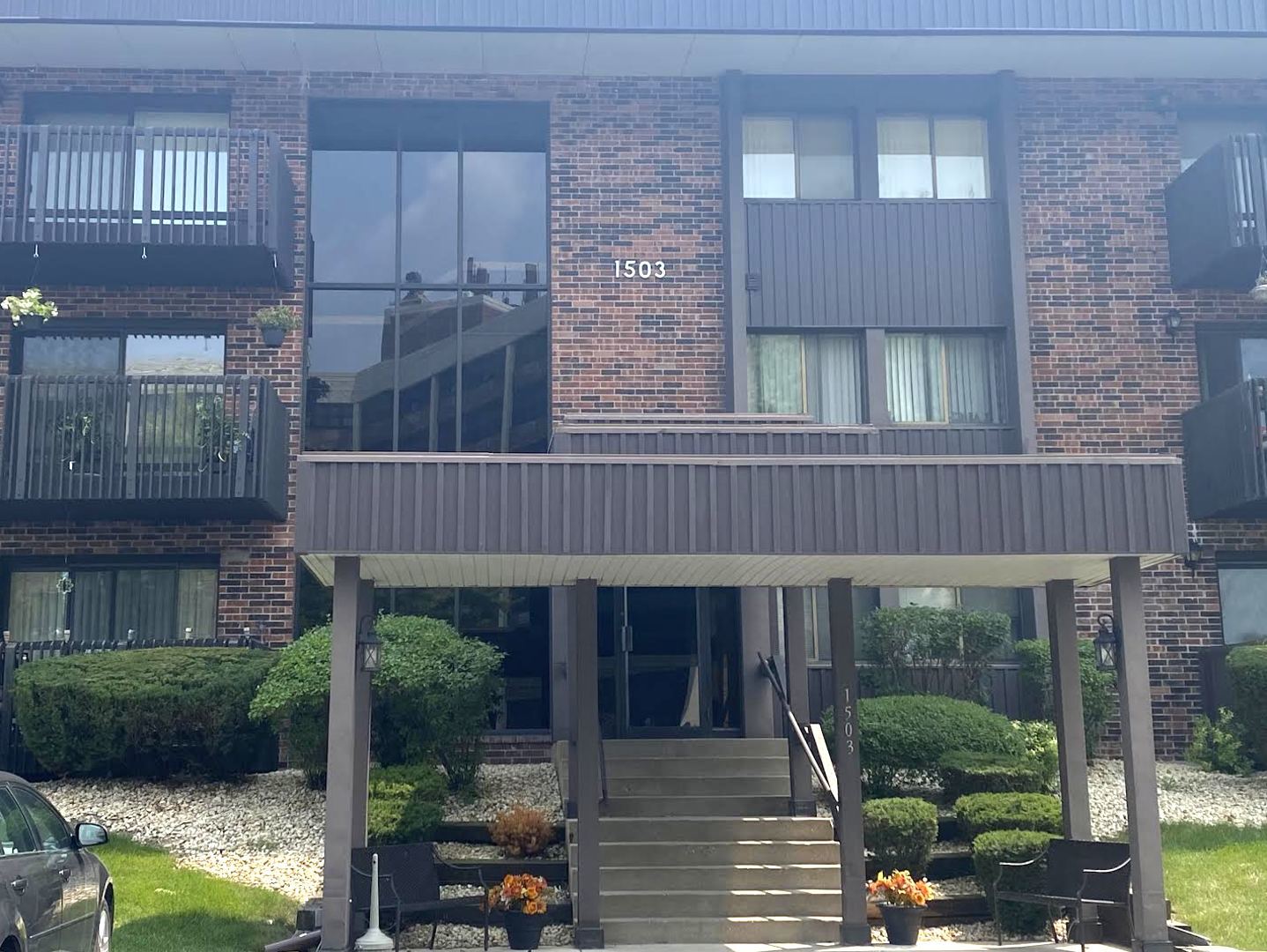 a view of a brick house with a yard