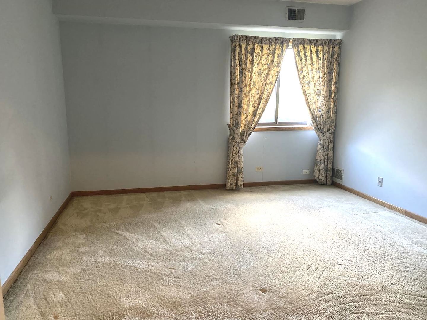 1503 Woodbridge Road, Unit 1C Joliet, IL 60436 - Photo 4 of 8 an empty room with a window