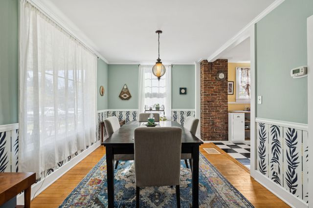 a dining room with furniture and window