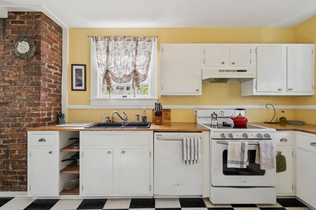 a kitchen with stainless steel appliances granite countertop a stove and a sink