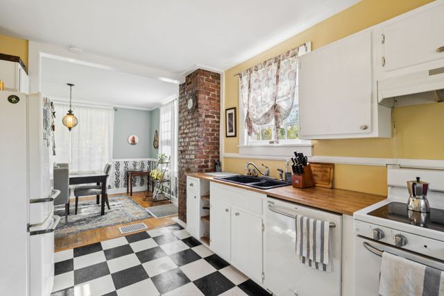 a kitchen with stainless steel appliances a stove a sink and a cabinets