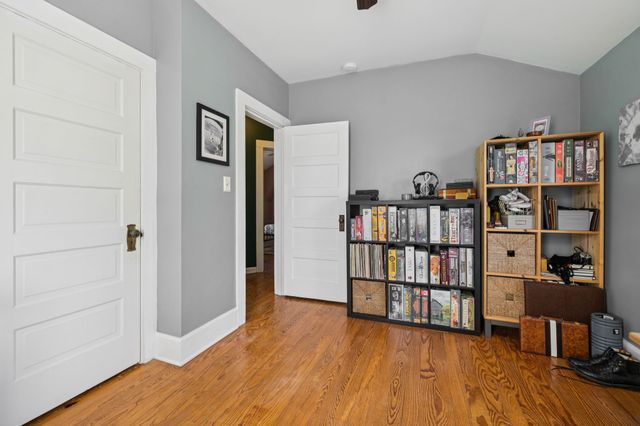 a view of a livingroom with furniture and book shelf