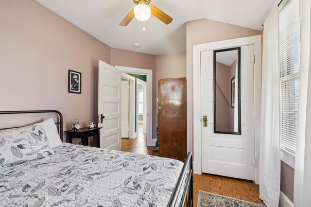 a bedroom with a bed and a mirror