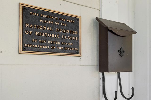 a view of a hallway with wooden floor and a wall painting