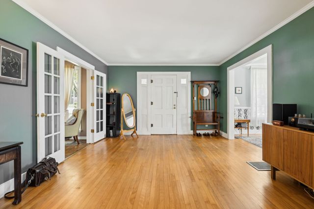 a view of a room with wooden floor and furniture