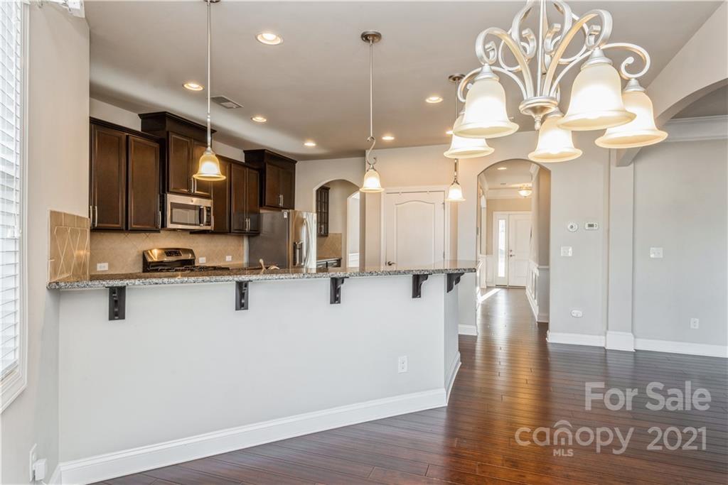 108 Kentmere Lane Clover, SC 29710 - Photo 11 of 36 a view of a kitchen with stainless steel appliances granite countertop a refrigerator a stove and a wooden floor