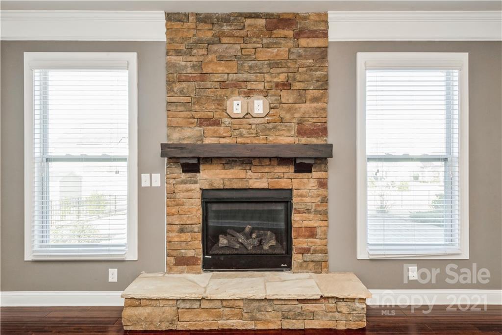 108 Kentmere Lane Clover, SC 29710 - Photo 14 of 36 a living room with a fireplace and windows