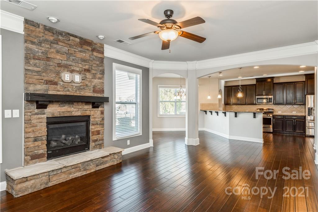 108 Kentmere Lane Clover, SC 29710 - Photo 15 of 36 a view of a livingroom with a fireplace wooden floor and a kitchen