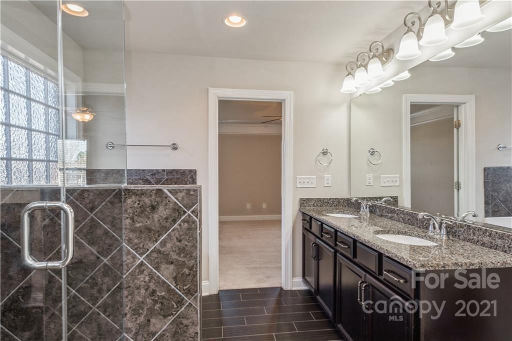 108 Kentmere Lane Clover, SC 29710 - Photo 25 of 36 a bathroom with a granite countertop sink a large mirror and a shower