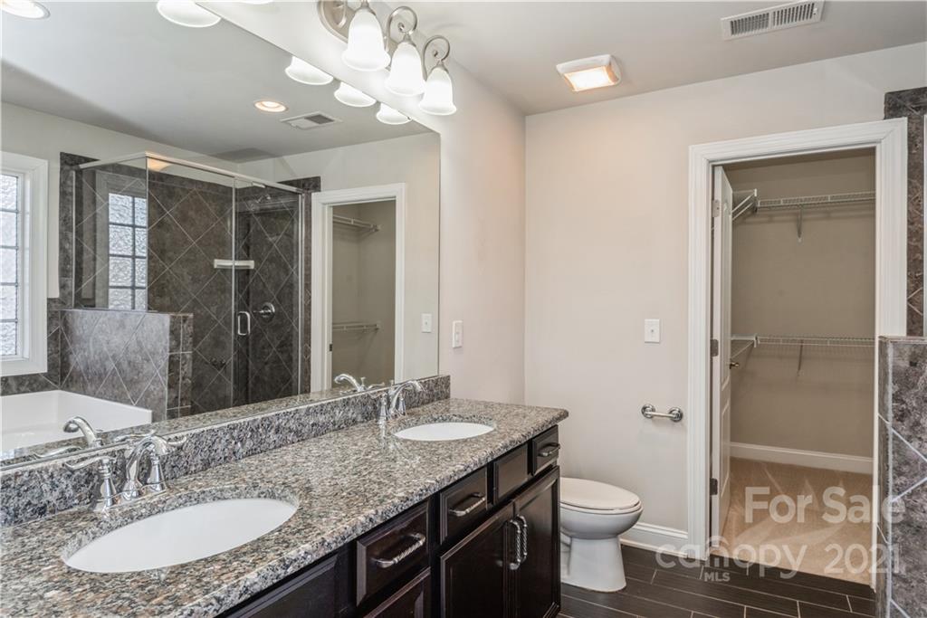 108 Kentmere Lane Clover, SC 29710 - Photo 26 of 36 a bathroom with a granite countertop sink a toilet a mirror and shower