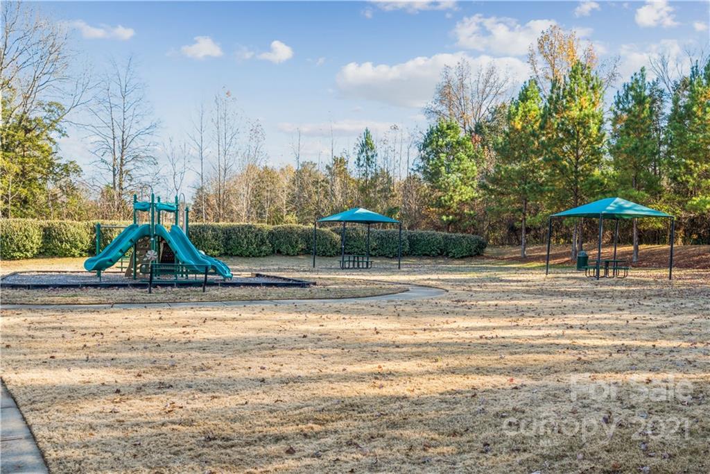 108 Kentmere Lane Clover, SC 29710 - Photo 36 of 36 a view of a swimming pool with a table and chairs under an umbrella
