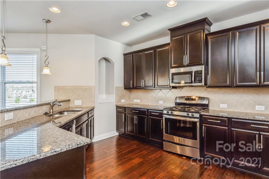 108 Kentmere Lane Clover, SC 29710 - Photo 8 of 36 a kitchen with stainless steel appliances granite countertop a stove a sink and a microwave