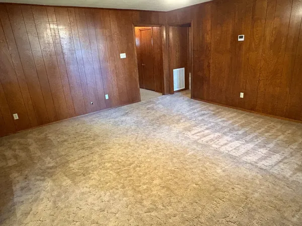 a view of an empty room with wooden walls