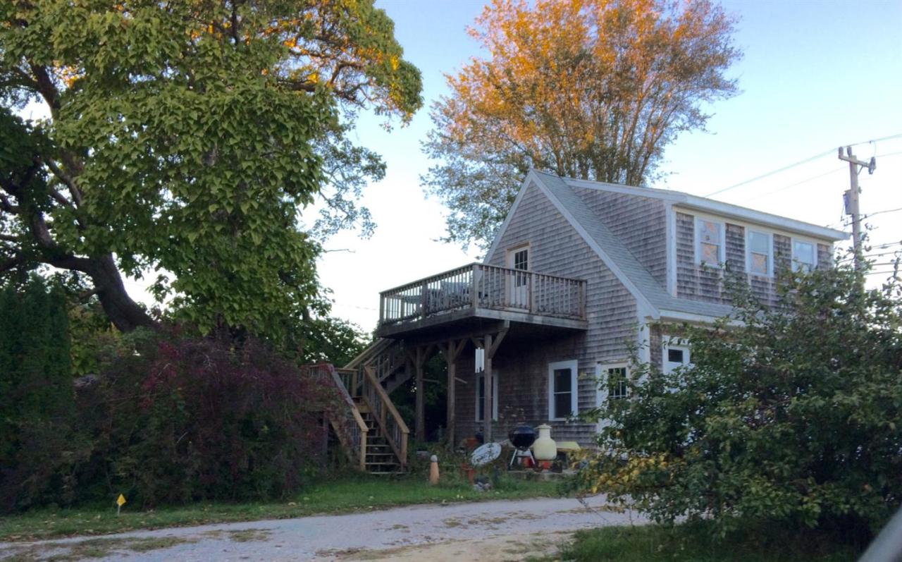 889 Orleans Road North Chatham, MA 02650 - Photo 8 of 10 a view of a house with large windows and a tree