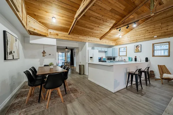 a dining room with furniture and wooden floor