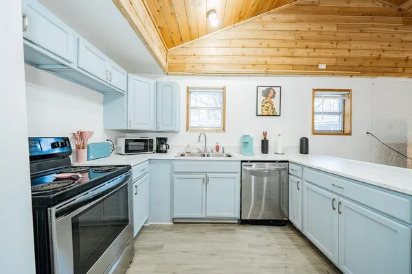 a kitchen with a sink stove and cabinets