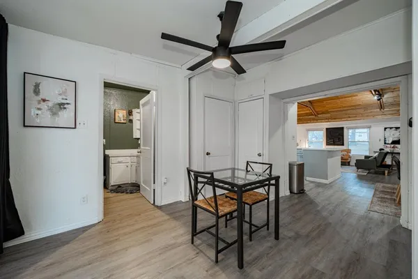 a view of a dining room with furniture and wooden floor