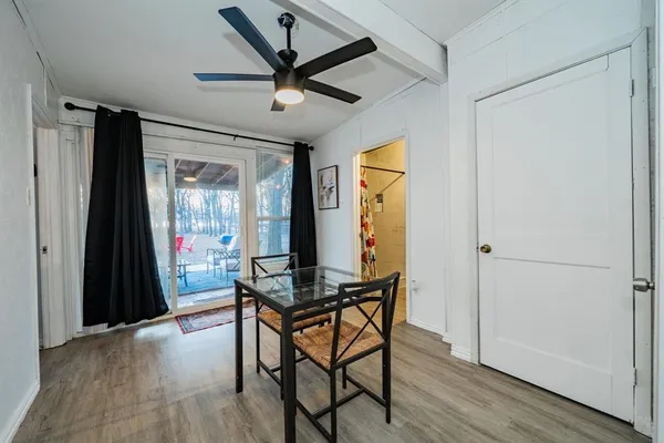 a workspace room with wooden floor and windows