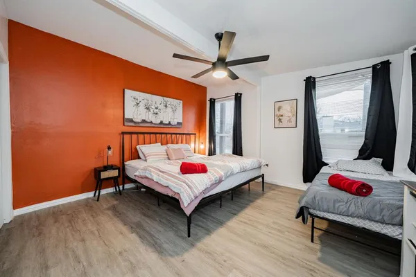 a bed room with a bed window and a flat screen tv