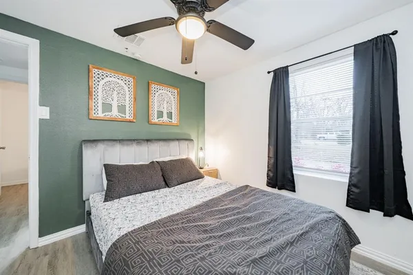 a bedroom with a bed and a large window