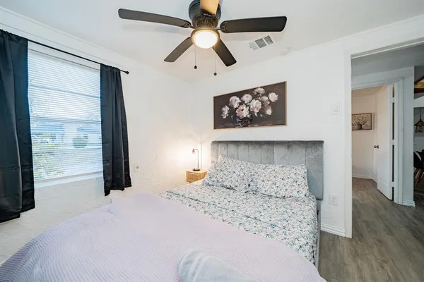 a bedroom with a large bed and a large window