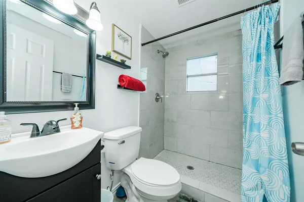 a bathroom with a sink toilet and shower