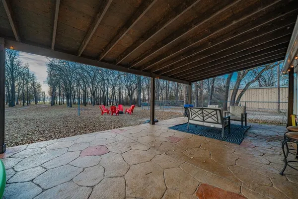a view of road with house and trees in the background