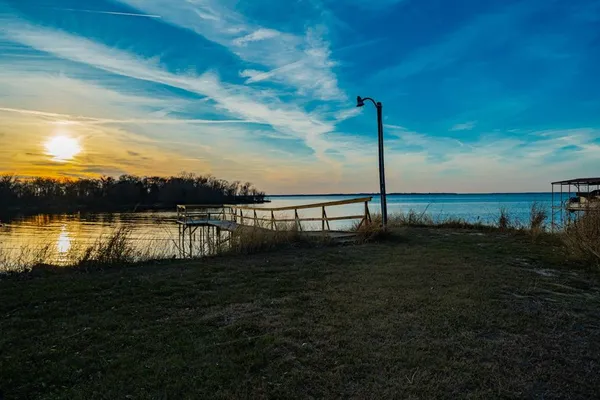 a view of a ocean next to a yard