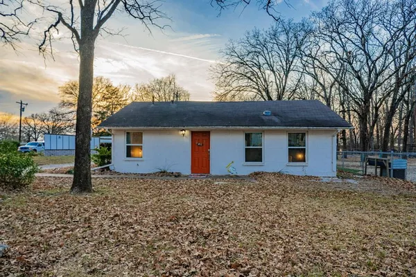 a front view of house with yard and trees