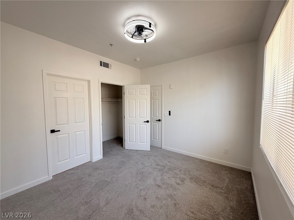 9050 West Warm Springs Road, Unit 2002 Las Vegas, NV 89148 - Photo 29 of 46 This inviting bedroom features soft carpet and ample natural light, perfect for serene living.
