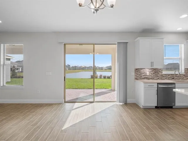 a large kitchen with kitchen island a sink stainless steel appliances and cabinets
