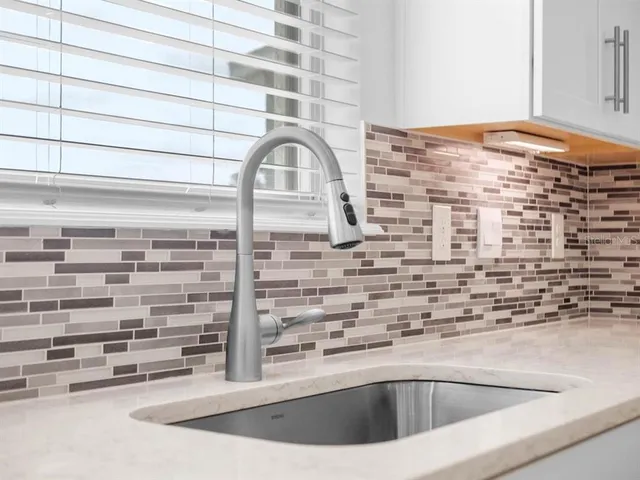 a view of staircase with railing and white walls