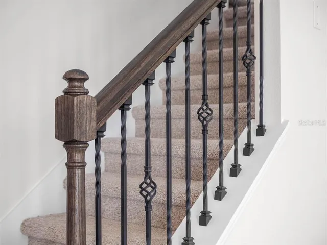 a view of staircase with white walls