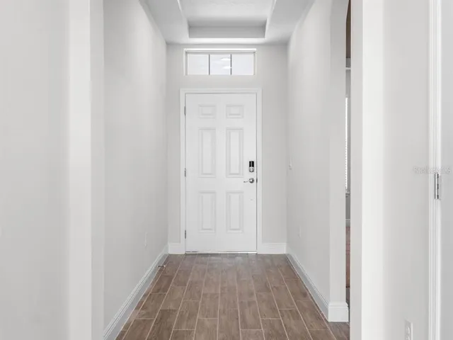 a view of a hallway with wooden floor