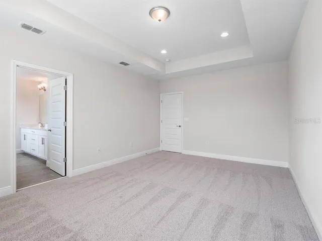 a spacious bathroom with a double vanity sink and a mirror