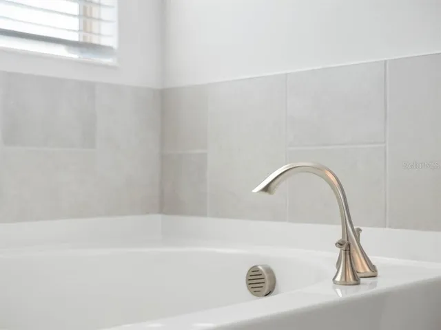 a view of room with walk in closet and wooden floor