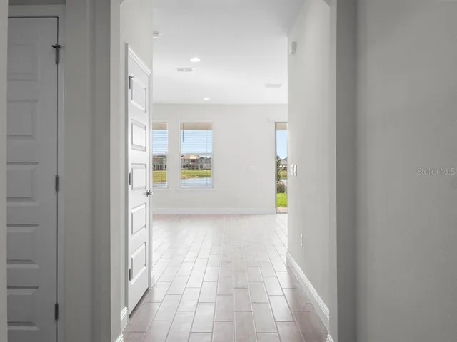 a view of an empty room with glass door
