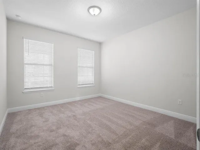 a bathroom with a shower sink vanity and toilet