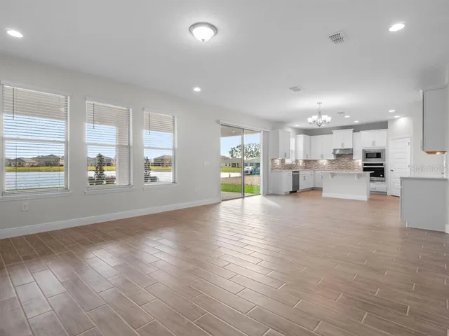 a view of a kitchen with a sink and a refrigerator