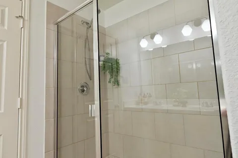 a bathroom with a shower and a mirror