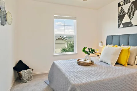 a bedroom with a bed and window