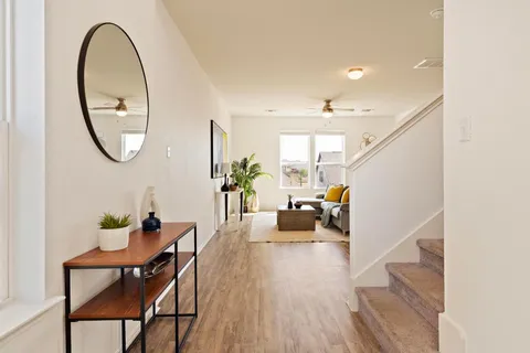 a living room with furniture and a potted plant