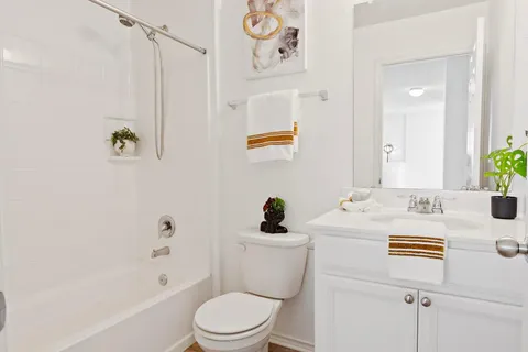 a bathroom with a sink a toilet and shower
