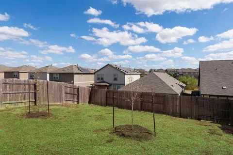 a view of a house with backyard and sitting area