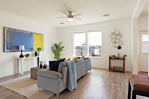 a living room with furniture and wooden floor