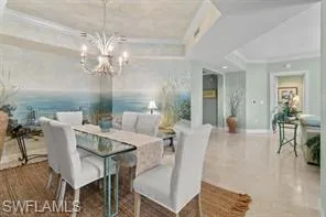 a view of a dining room with furniture a chandelier and wooden floor