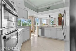 a kitchen with granite countertop a sink stainless steel appliances and cabinets