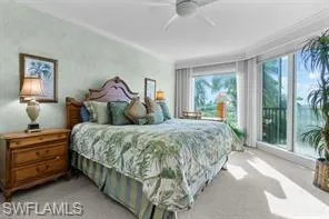 a bedroom with a large bed and a large window